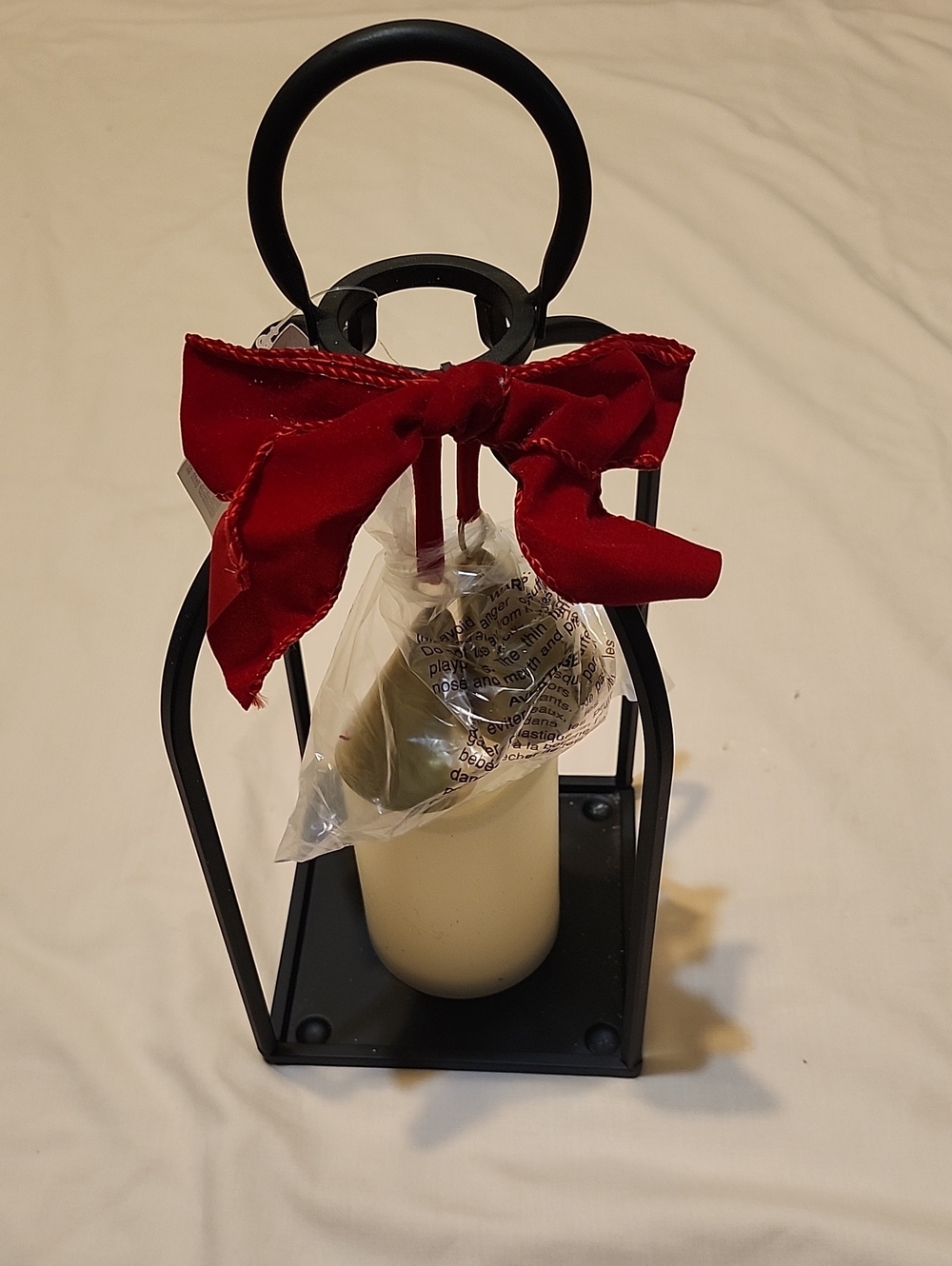 Decorative Lighted Black Metal Lantern with Red Bow and Cream Faux Candle